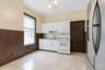 Kitchen featuring white cabinetry, a white gas range, and a stainless steel refrigerator