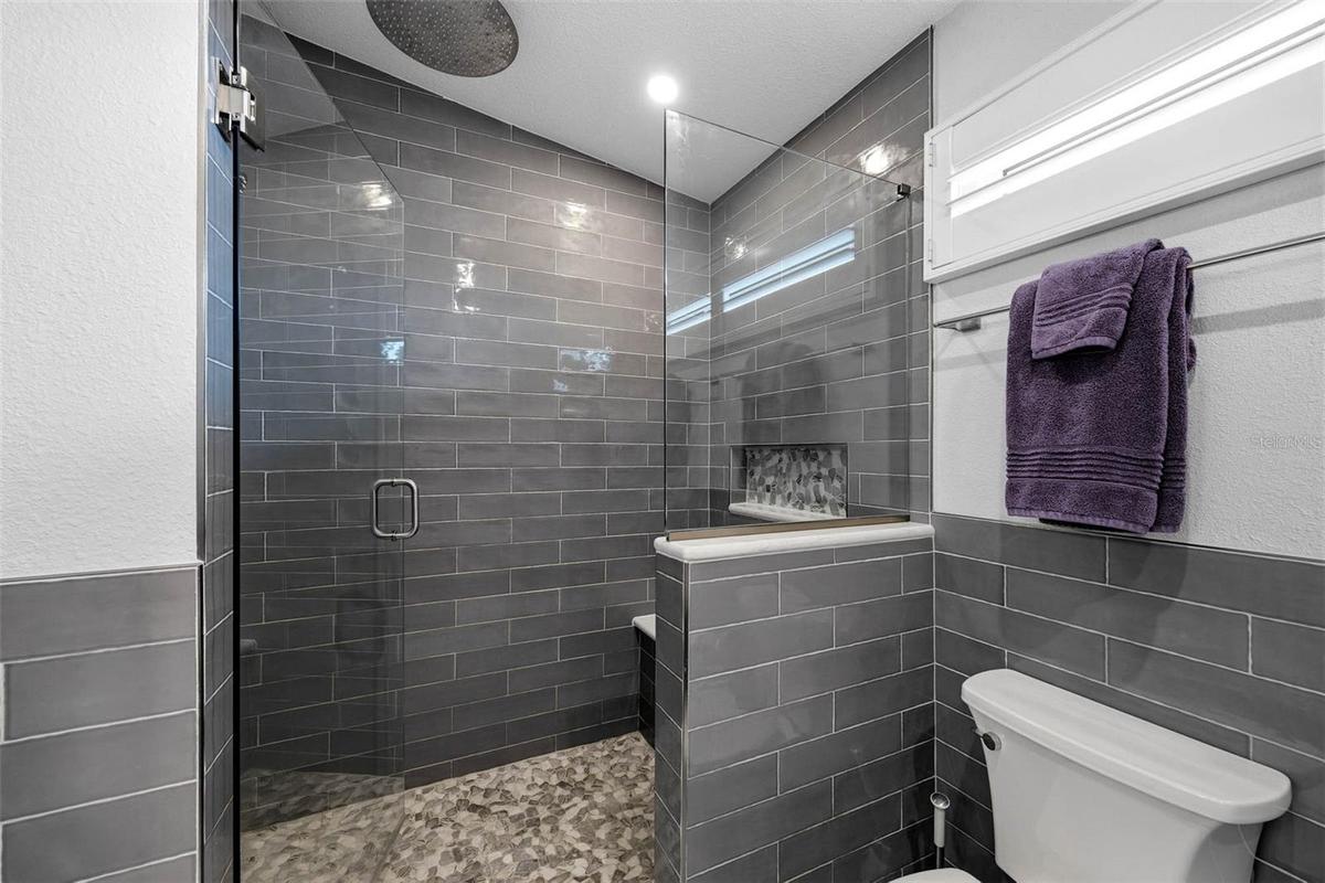 Beautiful tiled shower with rainfall shower head