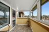 Balcony off of the Primary Suite with newer insulated roof and hurricane windows and gorgeous custom tile flooring.