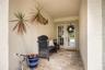 Main Entrance with lovely covered patio finished with travertine.