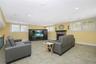 Spacious finished area featuring recessed lighting, tile flooring, and multiple windows