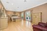 Spacious room featuring light wood-finish flooring and crown molding