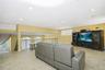 Spacious loft area featuring recessed lighting, tile flooring, and a media wall with built-in cabinetry
