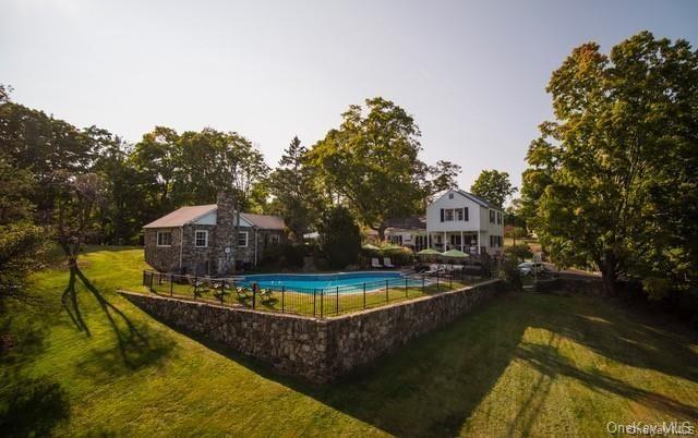 View of swimming pool featuring a yard