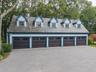 Garage with view of wooded area and a detached garage