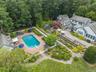 Drone / aerial view of a pool and a forest
