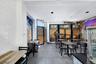 Spacious commercial interior featuring white subway tile accent wall and dark gray floor tiling