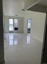 Empty room with plenty of natural light, light tile patterned flooring, and baseboards