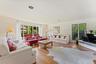 Sun filled living room with large windows