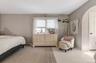 Spacious room featuring neutral painted walls and a light-toned area rug over a lighter floor