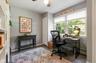 Dedicated room featuring dark wood-finish flooring, white built-in shelving, and light gray wall paint