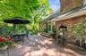 Brick patio featuring a built-in outdoor fireplace