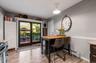 Kitchen area featuring wood-finish flooring, a built-in island with a wood countertop, and sliding glass doors providing access to an outdoor patio sp