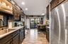 Kitchen featuring wood-finish flooring, dark cabinetry, recessed lighting, and stainless steel appliances