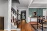 Entry foyer showcasing wood-finish flooring and a staircase with white risers and dark wood treads