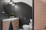 Modern bathroom featuring a wood-finish vanity with an integrated sink, brushed nickel faucet, and a circular mirror