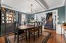 Dining area featuring wood-finish flooring, a coffered ceiling, and a chandelier