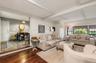 Living room with exposed ceiling beams and dark wood-finish flooring