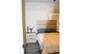 Located at the end of the hallway, this guest bedroom offers a queen-size bed, remote-controlled blackout blinds, and a quiet retreat for family or vi