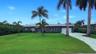 Beautiful Wilton Manors pool home with tropical landscaping, modern curb appeal, and a welcoming entrance that sets the tone for South Florida indoor-