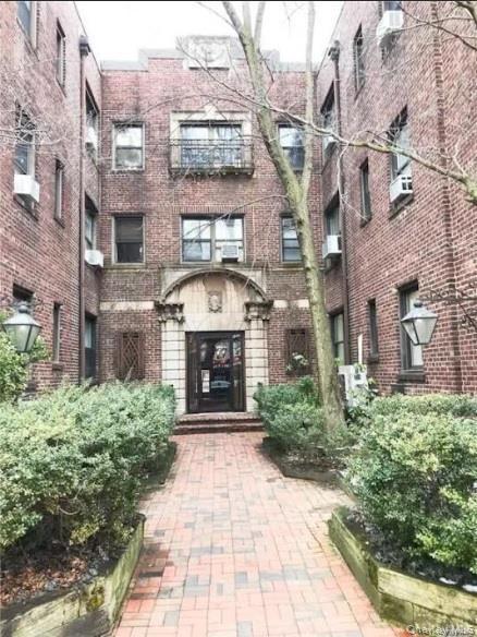Doorway to property featuring brick siding