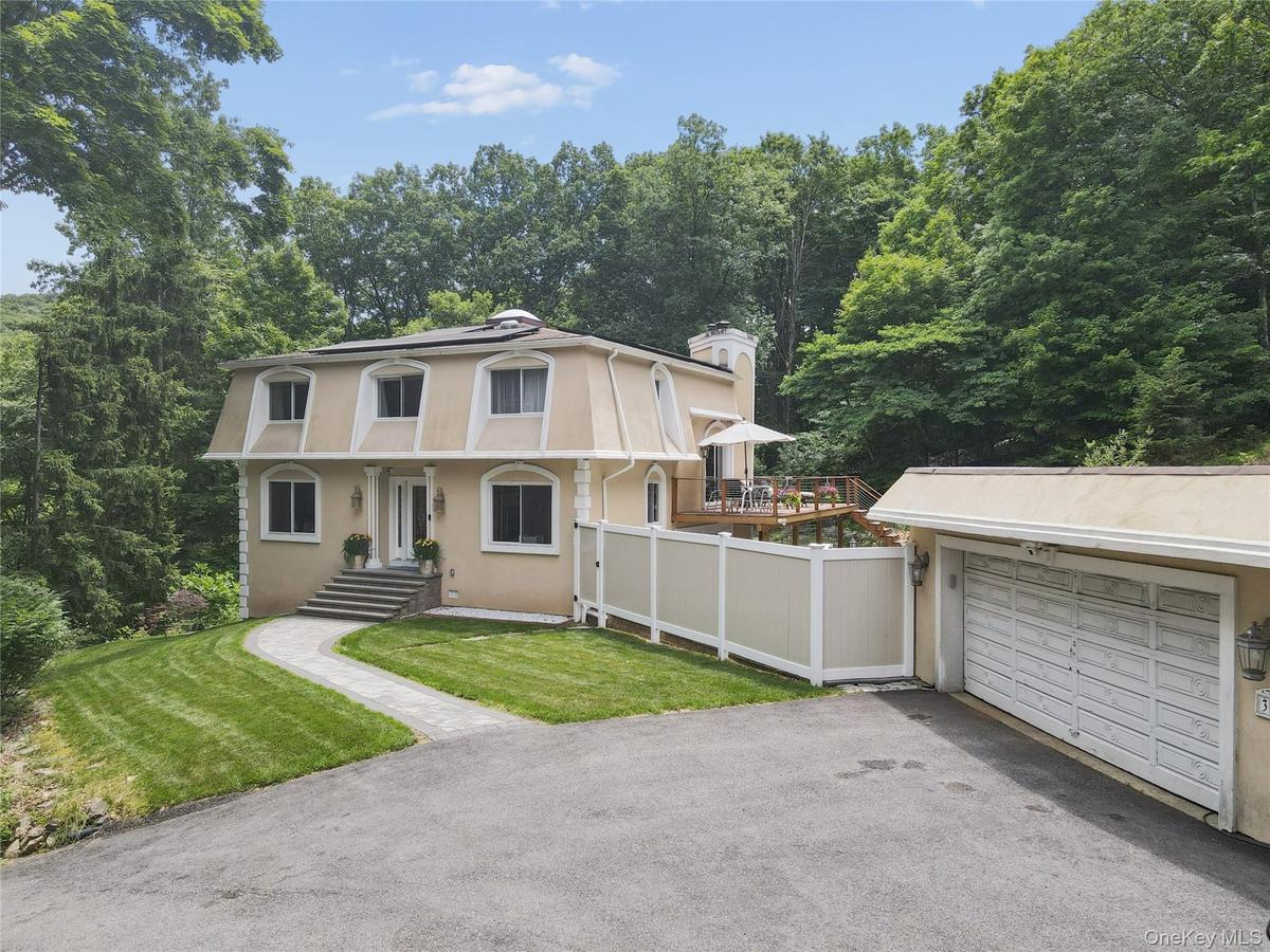Main entrance with detached 2 car garage and carport.