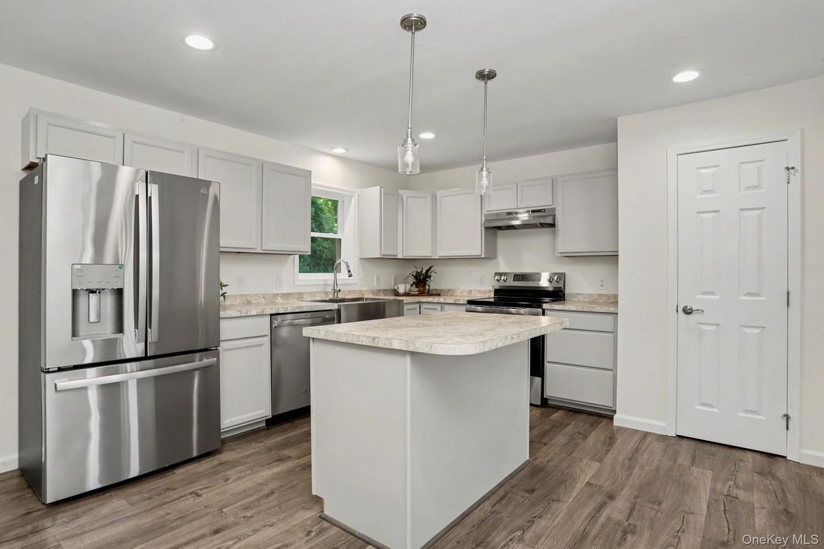 Kitchen with stainless steel appliances and pantry closet