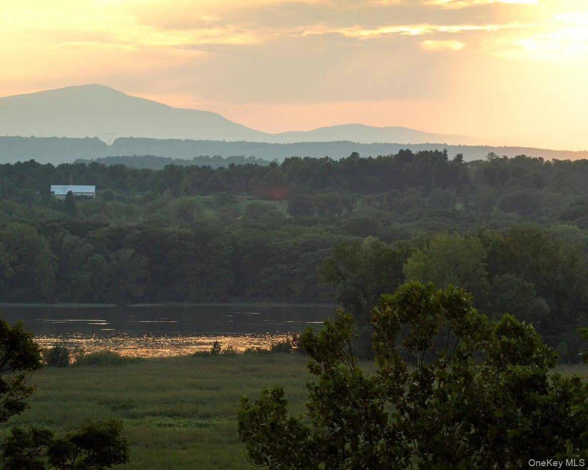 View of mountain feature featuring a water view and a wooded view