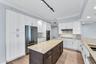 JENN AIR Refrigerator; JENN AIR Dishwasher; Thermador Induction Cooktop; Thermador Wall Oven Microwave Combo; New Cabinetry; Quartzite Countertops wit