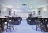 Theater with private screenings, and high top table and chairs, stadium lounge chairs.