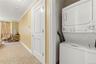 Laundry closet conveniently located outside the bathroom in the hall.