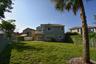 Not fenced, but neighbors are. Open common area is adjacent to the lot