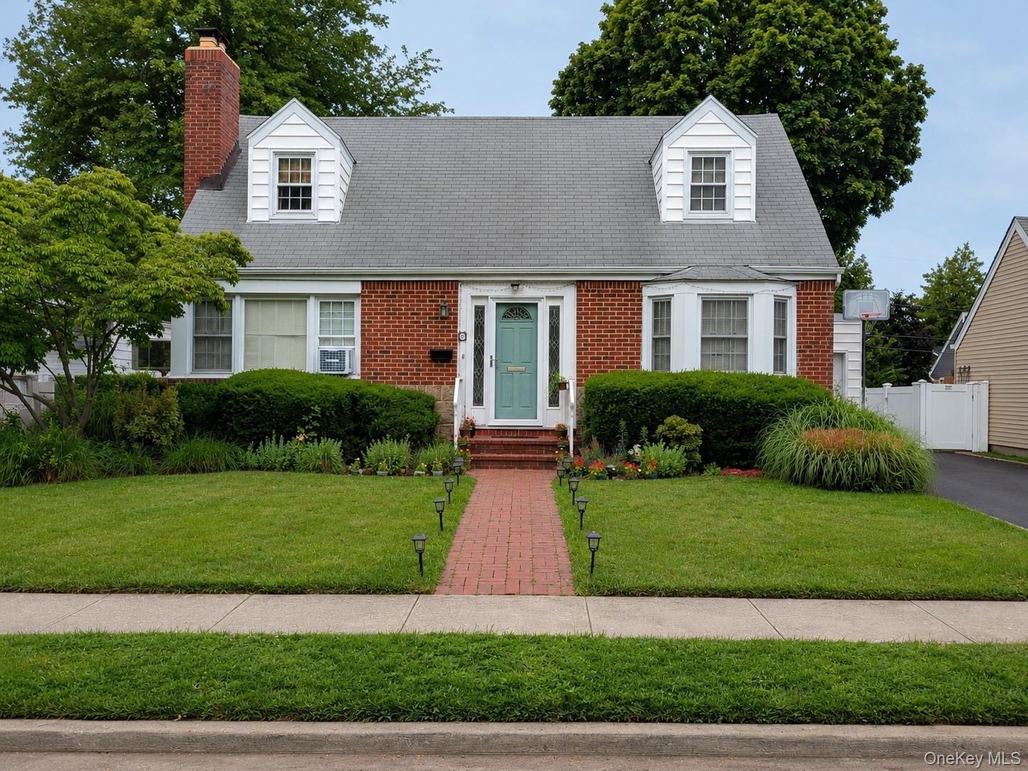Classic Cape Cod with tidy front yard