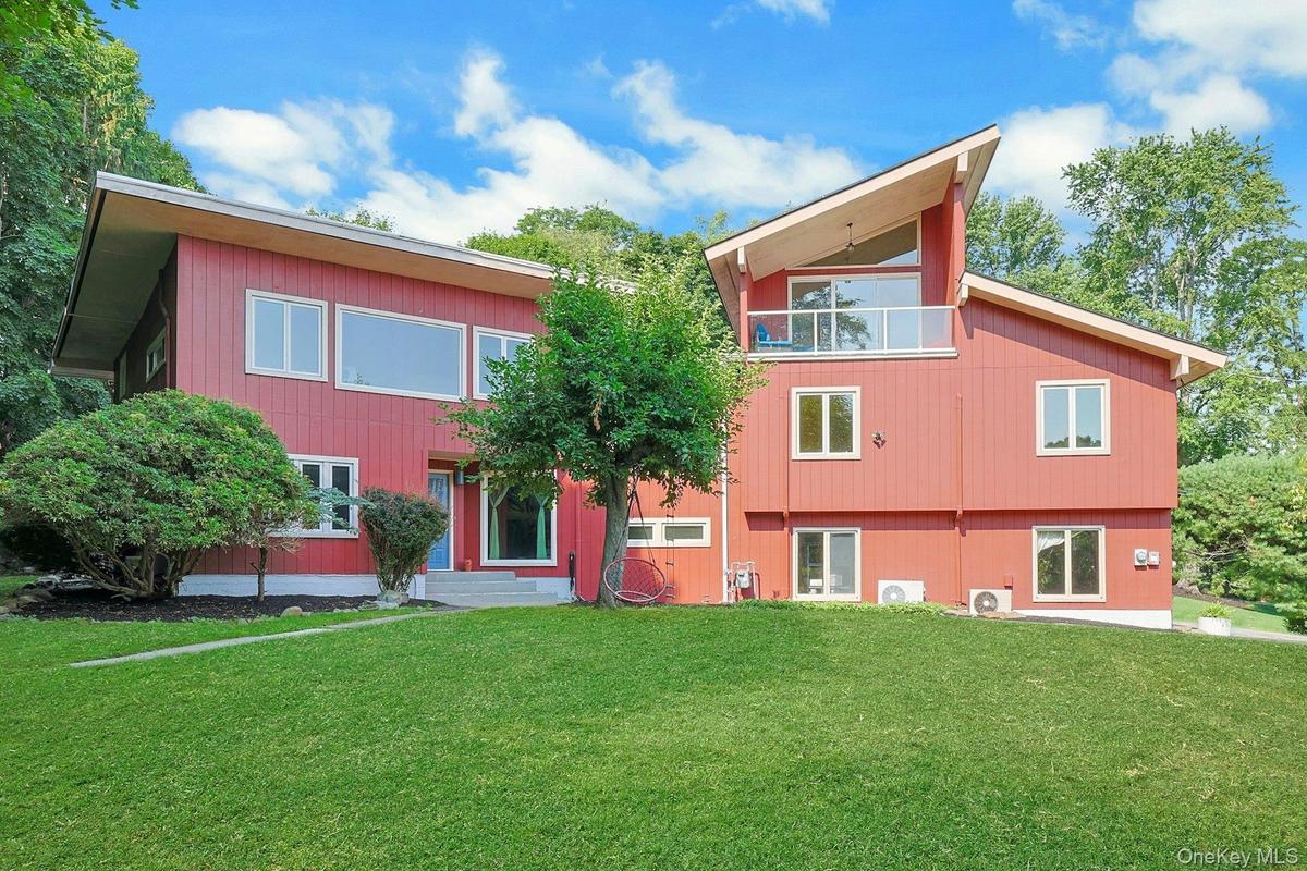 Perched atop a bluff in a quiet riverside neighborhood, this home has gorgeous views from many rooms, particularly the living room and the deck off of