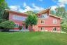 Perched atop a bluff in a quiet riverside neighborhood, this home has gorgeous views from many rooms, particularly the living room and the deck off of