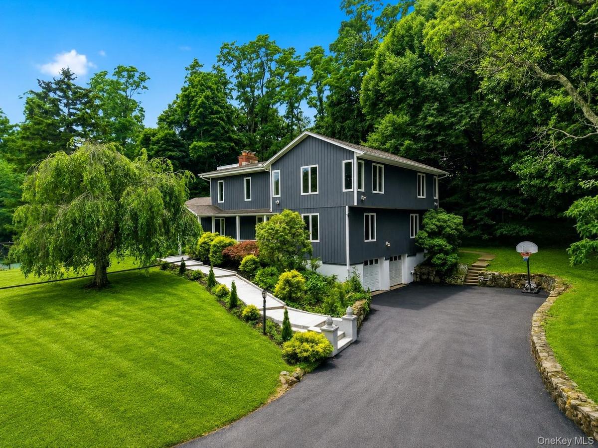 Contemporary two-story exterior with dark gray siding and white trim