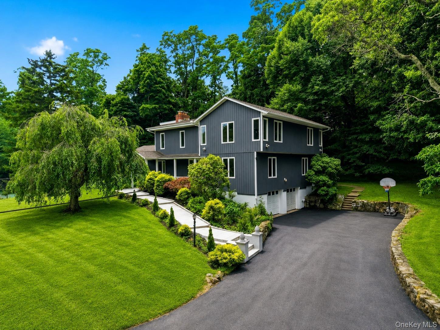 Contemporary two-story exterior with dark gray siding and white trim