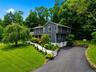 Contemporary two-story exterior with dark gray siding and white trim