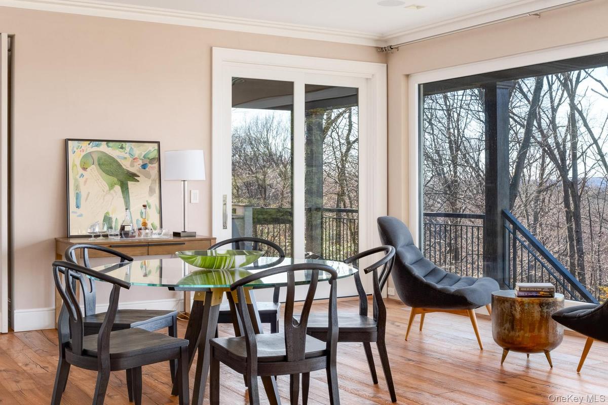 Sliding doors lead to a bluestone deck with outdoor kitchen.