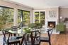Open floor plan with dining area off large living room features gas fireplace.