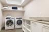 Spacious lower level laundry center.