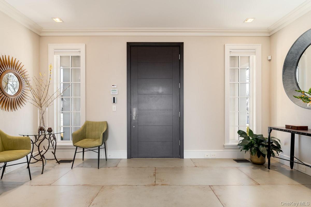 Elegant entry foyer enhanced with porcelain tile floors.