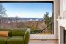 Panoramic windows offer stunning views of the Hudson River and beyond.