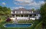 Rear view of house with heated salt water pool and multiple outdoor living areas.