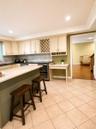 light-toned cabinetry, a built-in wine rack, and a beverage refrigerator