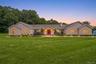 Single-story home featuring a broad front lawn
