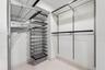 ..  Master  Bedroom Walk In Closet with designer built-ins including ELFA Master Closet System.