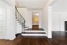 Stairs with wood finished floors, visible vents, and baseboards