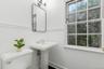 Bathroom with toilet, a sink, and baseboards