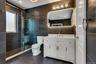 Contemporary bathroom featuring slate-toned tiled walls and flooring
